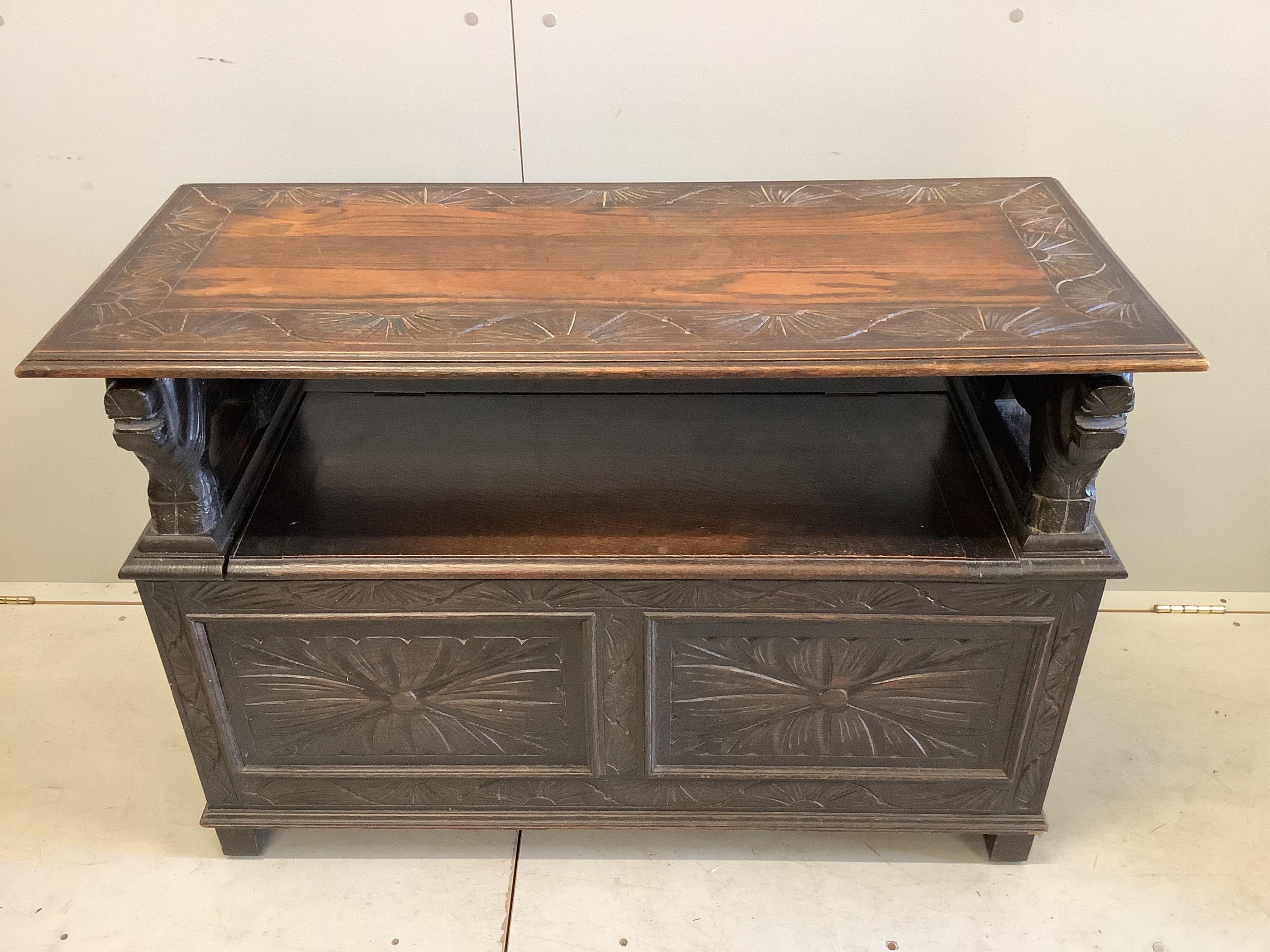 An early 20th century carved oak monk's bench, width 107cm, depth 45cm, height 173cm
